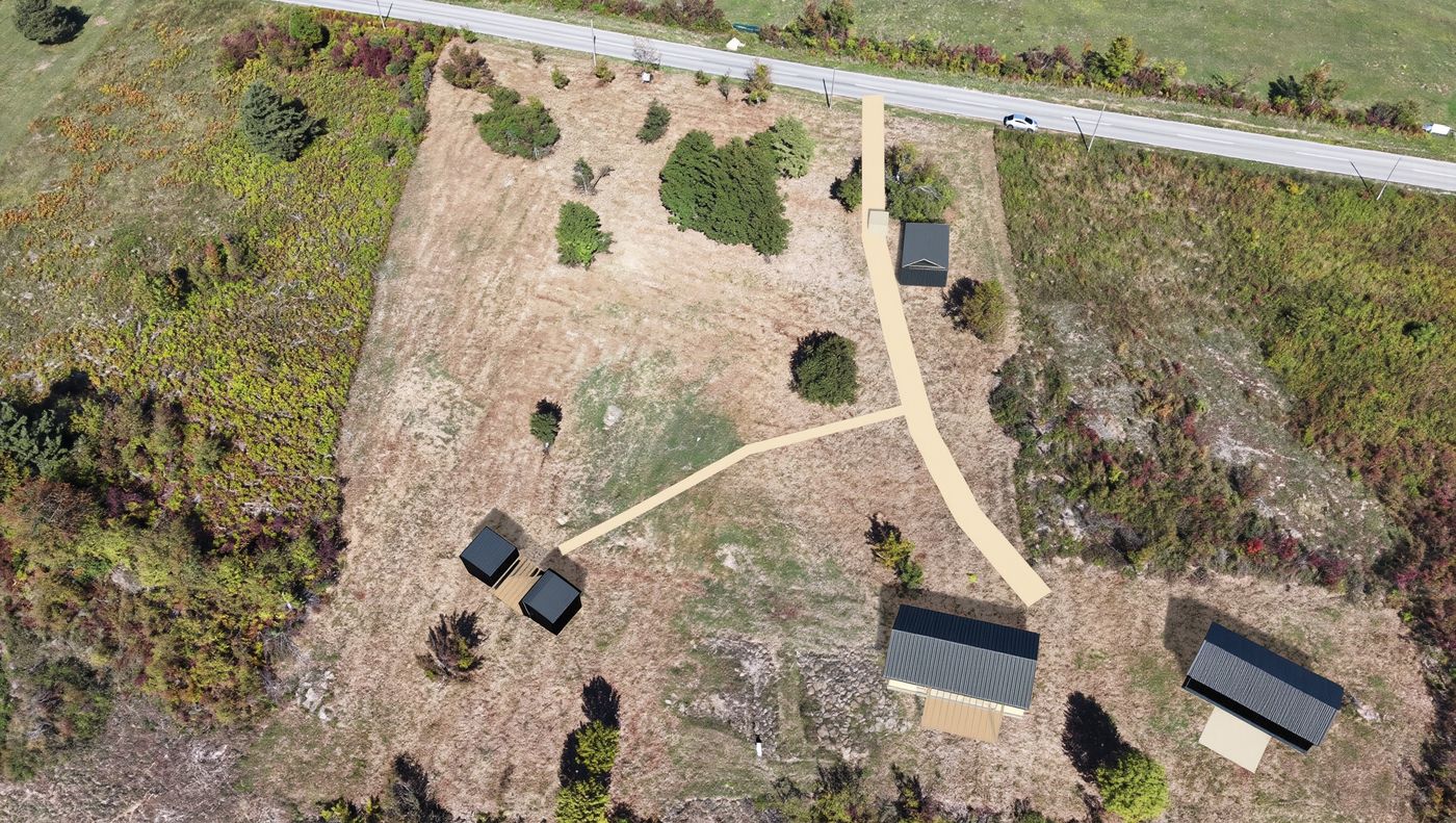 Concept: the same kind of aerial view with the studio, house and two guest pods placed on the land